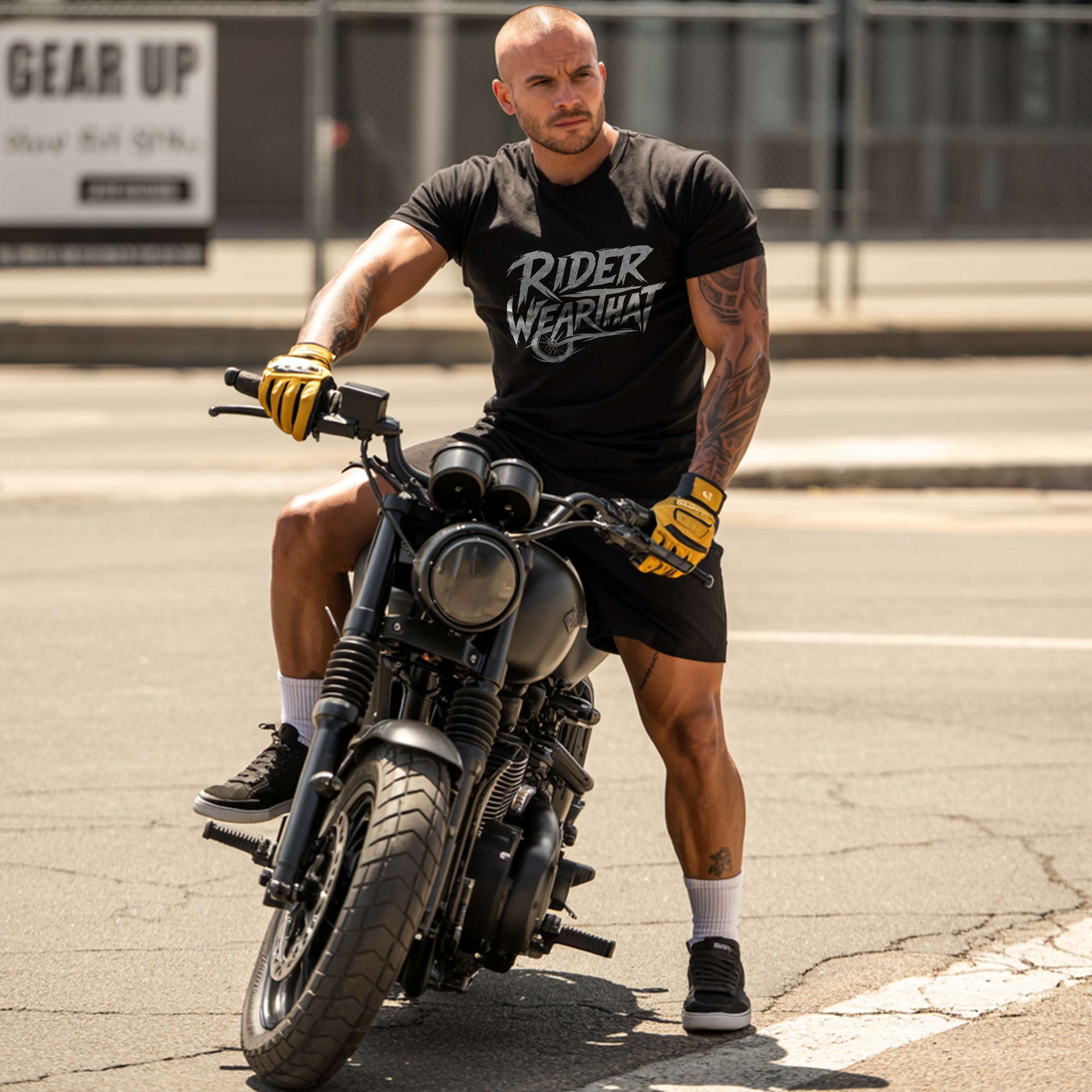 Man riding a motorcycle wearing a black t-shirt with 'Rider Wear' logo.